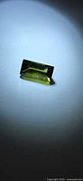 Baguette-cut green tourmaline under spotlight