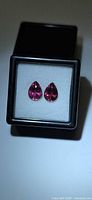 Pair of pear-cut pink rubelite gemstones in display box