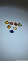 All six oval sapphires laid out showing colour range