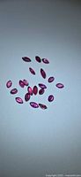 Group of marquise-cut rubies on light background