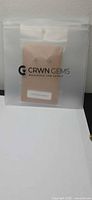 Sealed CRWN Gems pouch containing earring card