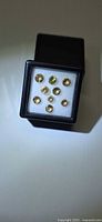 Black box containing nine round champagne yellow faceted gemstones