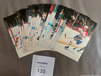 All 22 color postcards fanned out showing front action images