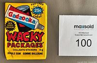 Front of sealed 1988 O-Pee-Chee Wacky Packages wax pack alongside lot number card