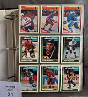 Binder page with nine base and Super Rookie cards visible