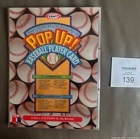 Front cover of collector’s album showing Pop Up Baseball Player Card artwork