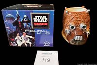 Mug and front of original box showing Star Wars branding and figural mug label
