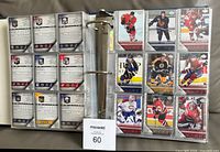 Binder opened showing multiple nine-pocket pages with 2005-06 Upper Deck hockey cards, visible Young Guns rookies.
