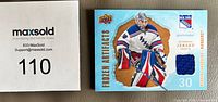 Front of the Henrik Lundqvist Frozen Artifacts jersey swatch card beside lot number card