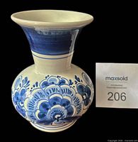 Front view of Delft blue and white earthenware vase with lot number card