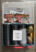 Closed plastic case with stacked medallion coins and wrappers