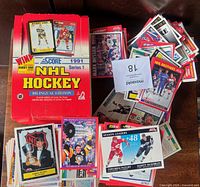 Original red Score 1991 Series 1 NHL Hockey box with stacks of loose cards and several star cards visible