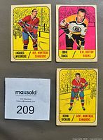 Front view of all three cards showing player images and team information
