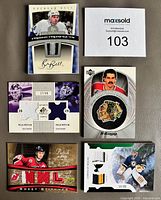 All five NHL jersey patch cards laid out showing fronts and serial numbers