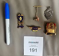 Group image showing all five metal items with marker for scale