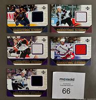 Front view of all five jersey cards showing player images and fabric swatches