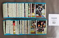 Two stacks of 1989-90 Topps hockey cards, Mario Lemieux #1 and Al Iafrate cards visible