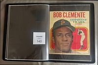 Binder open showing Roberto Clemente poster in sleeve