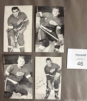 Group shot of four Detroit Red Wings promotional postcards showing player images and printed signatures