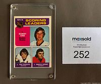 Front view of 1975-76 O-Pee-Chee card #210 in screwdown holder