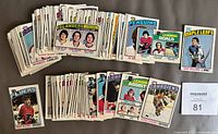 Front view of assorted 1976-77 O-Pee-Chee hockey cards spread in two rows