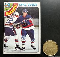 Front of Mike Bossy rookie card beside Canadian dollar for scale