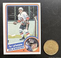 Front of Pat LaFontaine rookie card beside coin for scale