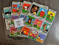 Fronts of multiple Peanuts cards in binder pages