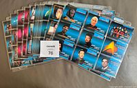 Stack of Ultra Pro pages with Star Trek TNG cards showing character and starship fronts