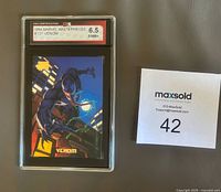 Front of KSA-slabbed Venom card showing grade label