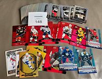 Overview of entire lot showing stacks of Cup Winners, Red Die-Cut, Gold Etchings, Canvas and Clear Cut Phenoms cards with MaxSold lot number