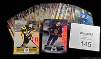 Spread of stacked hockey cards plus close-ups of Sidney Crosby and Connor McDavid cards