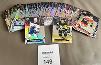 Spread of entire 120-card stack with three sample fronts including Connor McDavid, Sidney Crosby, Tim Stutzle