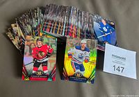 Front view of stacked 2024-25 Tim Hortons hockey cards with Connor Bedard and Connor McDavid cards visible