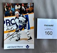 Full view of signed Daniel Marois photo with lot card