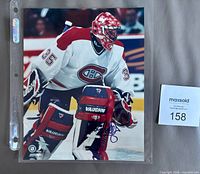 Full view of signed 8" x 10" Jose Theodore Canadiens photo in plastic sleeve with MaxSold lot card