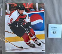 Full photo in sleeve with MaxSold tag visible