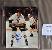 Full view showing autographed 8" x 10" photo in sleeve with blue signature