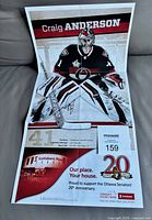 Full view of folded autographed poster showing Craig Anderson image and 20th Anniversary graphics