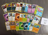 all 29 Pokémon cards spread out face-up showing mix of characters, types and energies