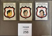 Fronts of three 1972-73 O-Pee-Chee crest insert cards in sleeves