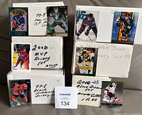 All seven boxed hockey card sets with sample cards displayed