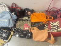 Group shot of 13 assorted purses laid out