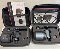 Two complete Matterport Axis gimbal sets in open cases showing gimbal units, clamps, arms, adapters, cables and manuals