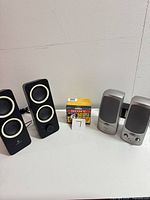 Two sets of speakers and Sony cassette pack displayed