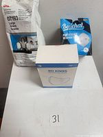 Sealed 3M respirator pack, full KN95 mask box, partial N95 mask box on table