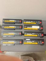 Eight Lenovo batteries laid out in two columns