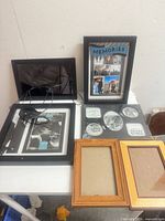Digital photo frame and five picture frames displayed on table