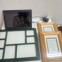Lot overview showing digital photo frame, green collage frame, two oak frames