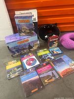 Group shot of all travel books, boxed sets, atlas and two neck pillows